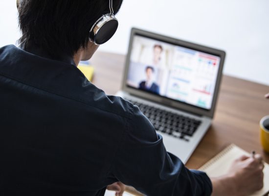 A businessman is having an online meeting with a client